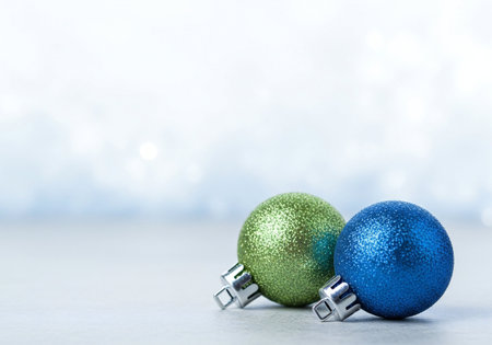 Christmas balls on blue bokeh background with copy space for your textの写真素材