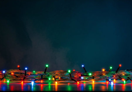 Colorful christmas lights on a dark background with copy space.の写真素材
