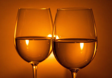 Two glasses of white wine on a yellow background. Close-up.の写真素材