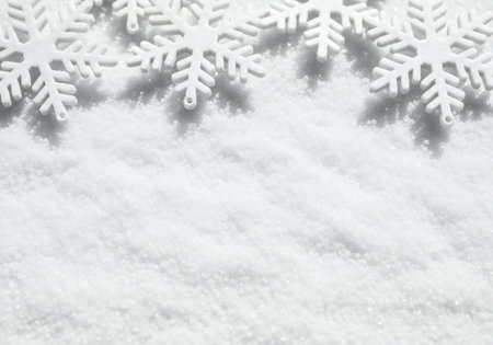 Snowflakes on the snow background with copy space for your textの写真素材