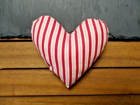 striped heart on a wooden backgroundの写真素材