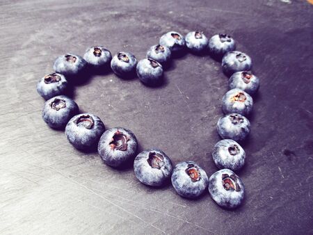 blueberry heart on a slate boardの写真素材