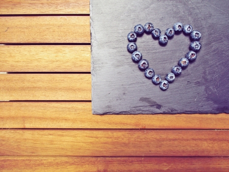 blueberry heart on a wooden backgroundの写真素材