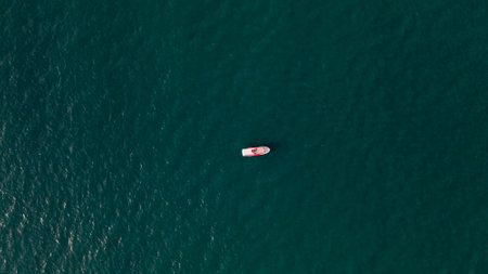 Aerial view of a small boat in the middle of the sea