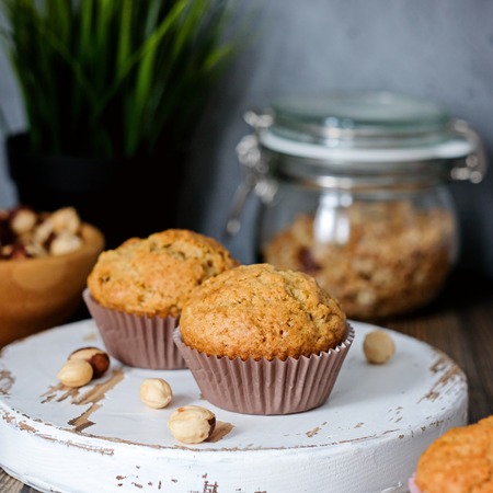 Homemade muffins, hazel nuts around on the deskの写真素材