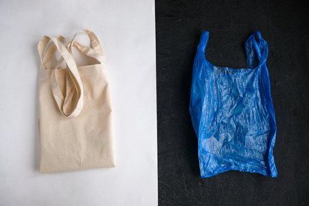Plastic free concept. Cotton bag and plastic bag on white and black background. Flat layの写真素材