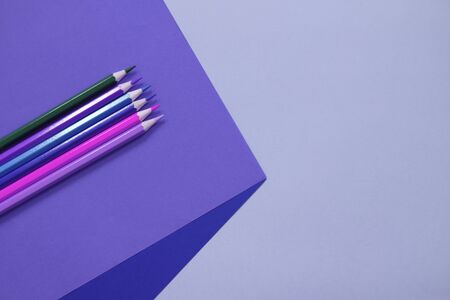 Abstract geometric paper background with color pencils. Blue and violet colors. School and education concept.の写真素材