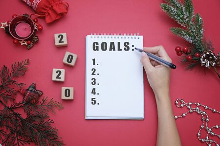 Christmas and new year 2020 concept, wooden cubes and decorations on red backgroundの写真素材