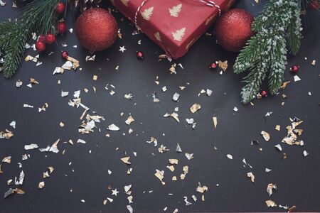 Black festive background with red and golden decoration, Chrtistmas and new year greeting card with...