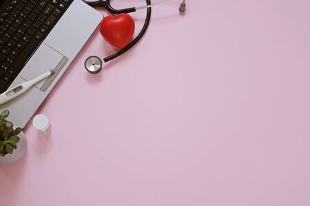 Doctors workplace, medicine flat lay: computer, stethocrope, termometer, heart with copy spaceの写真素材