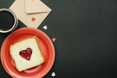 Composition for valentines day card with coffee, enveloope and sandwich heart shaped