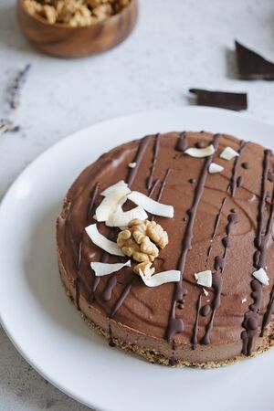 Chocolate raw vegan cake - healthy dessert made from coconut oil, cashew, cacao, walnut
