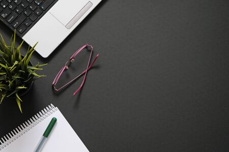 Flat lay with office supplies, computer and plant with copy space