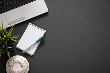 Flat lay with office supplies, computer and plant with copy space