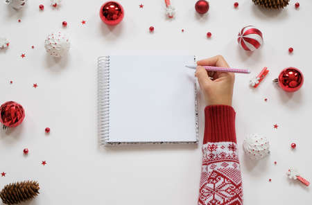 Goal lift for New Year. Holiday decorations and notebook with clean note book on white table, flat lay style. Planning concept.の写真素材
