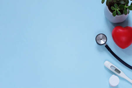 Doctor medicine flat lay: stethocrope, termometer, flower, heart