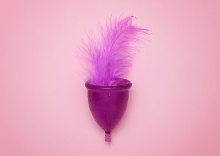 Menstrual Cup with feather on pink backgroundの写真素材