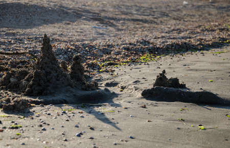 Children's sand castle on the beach at sunsetの写真素材