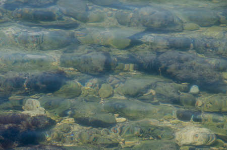 Sea floor with pebbles underwater. Pure water.の写真素材