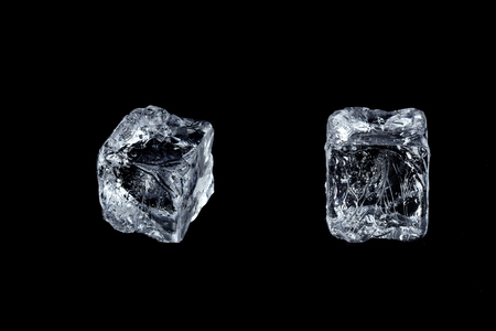 two ice cubes on black backgroundの写真素材