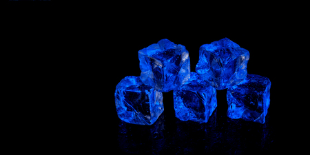 five blue ice cubes on black backgroundの写真素材