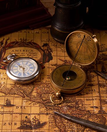 Old vintage retro compass on ancient world map. Vintage still life. Travel geography navigation concept background.の写真素材