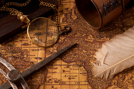 Old vintage retro compass on ancient world map. Vintage still life. Travel geography navigation concept background.の写真素材