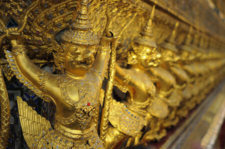 Golden Garudas lining at royal grand palace, bangkok Thailandの写真素材