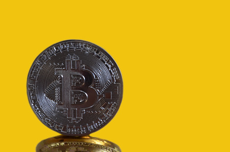 Bitcoin coin on a Golden backgroundの写真素材