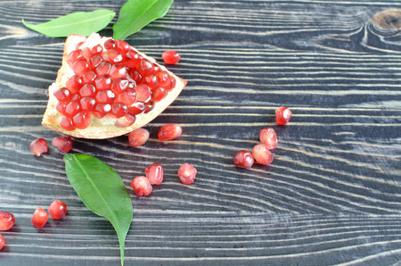 Red juicy pomegranate with red seeds on dark backgroundの写真素材