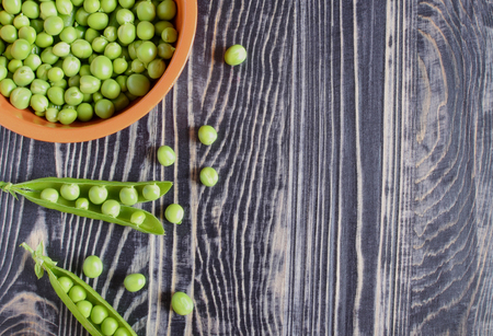 peas on a dark wooden backgrounの写真素材