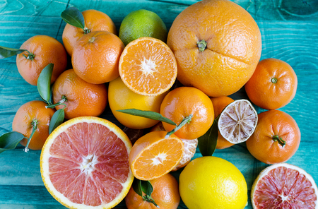 Tangerines lemons oranges lime citrus close-up on green background copy spaceの写真素材