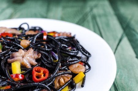 spaghetti black with seafood and vegetablesの写真素材