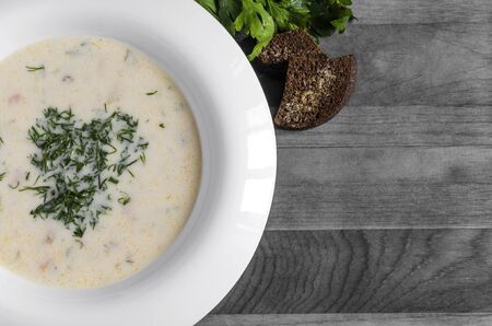 Cheese soup with vegetables in a white plateの写真素材