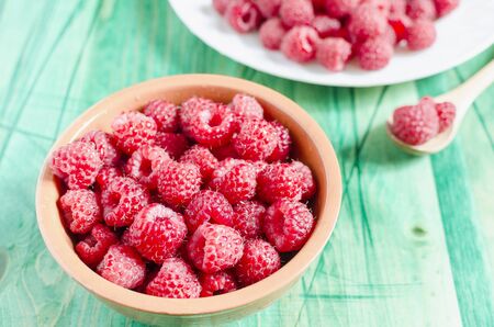 ripe juicy raspberries on a wooden background top view side viewの写真素材