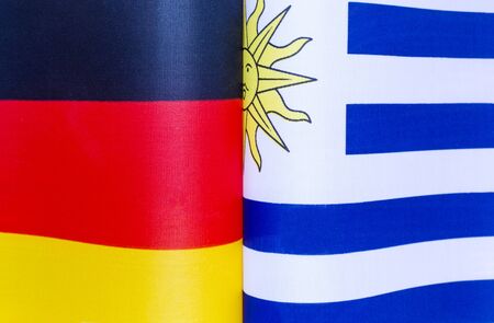 national flags of Germany and Uruguay close-up policyの写真素材
