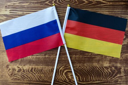 national flags of Germany and Russia closeup wooden backgroundの写真素材