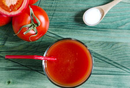 Tomato juice, tomatoes and salt on wooden background top viewの写真素材