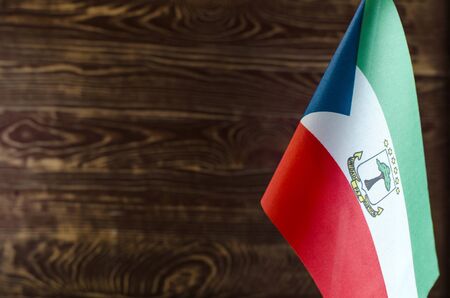 Fragment of the flag of the Republic of Equatorial Guinea in the foreground space for text blurred...