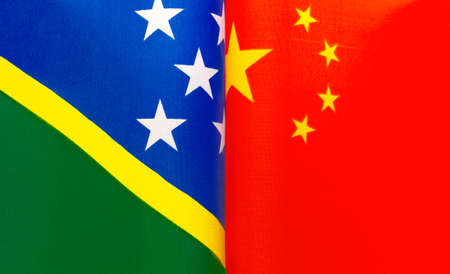 fragments of the national flags of the Solomon Islands and China in close-upの写真素材