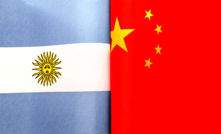 fragments of the national flags of the Argentine Republic and China in close-upの写真素材