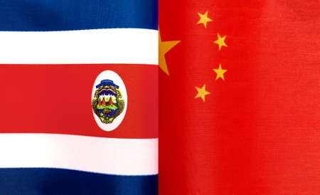fragments of the national flags of the Republic of Costa Rica and China close-upの写真素材