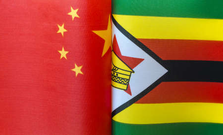 fragments of the national flags of China and the Republic of Zimbabwe close upの写真素材