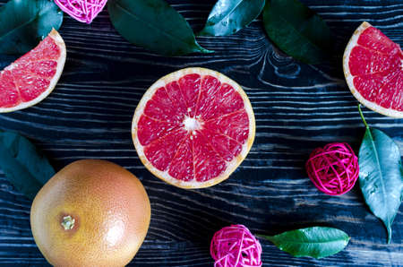 grapefruit slices grapefruit decorative elements and green leaves on a dark wooden background top...