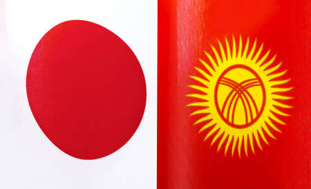fragments of the national flags of Japan and the Kyrgyz Republic close-upの写真素材