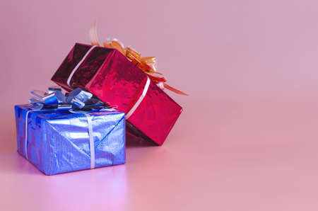 gift boxes surprises in bright packaging on a pink background space for textの写真素材