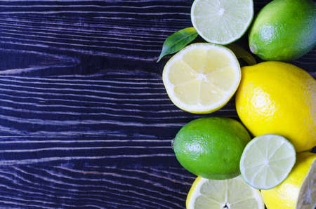 tangerines lemons oranges limes citrus fruits close up on a wooden background kopi spaceの写真素材