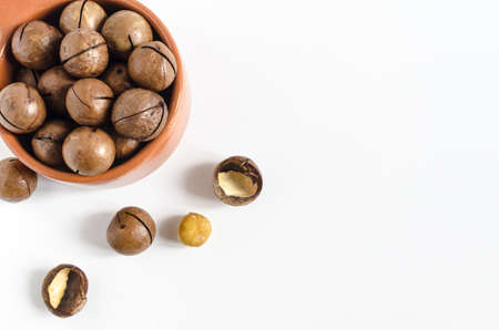 sweet macadamia nut in a brown dish on a light background of copyspaceの写真素材