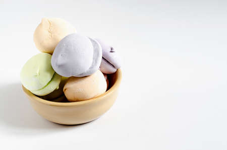 sweet airy dessert in clay dishes on a white background close-up of colorful marshmallowsの写真素材