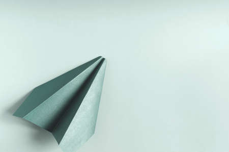 Concept paper airplane in green color on a green background of kopi space. Origami bright green paper airplaneの写真素材